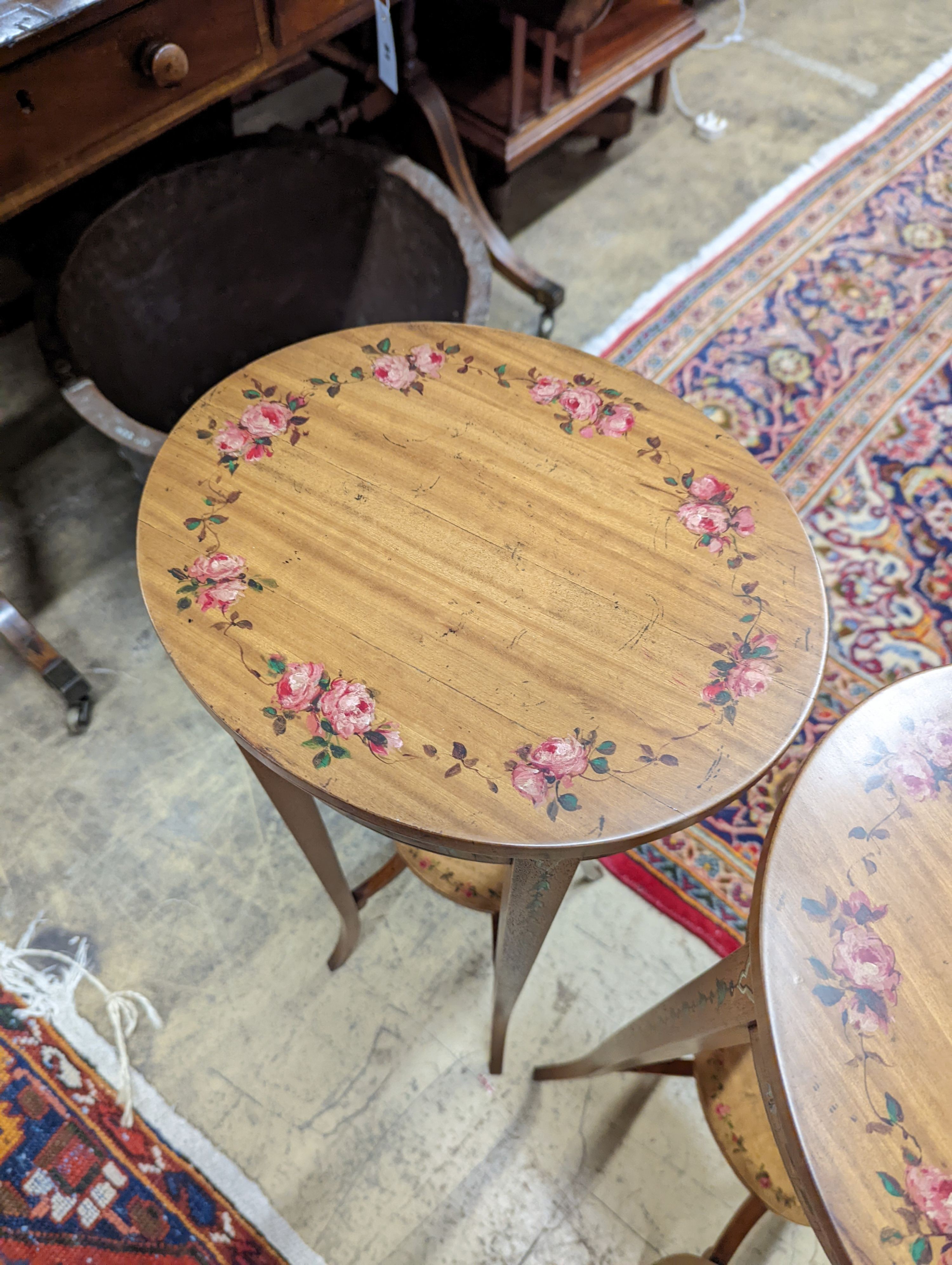 A pair of Sheraton style oval painted satinwood occasional tables, width 31cm, depth 26cm, height 71cm